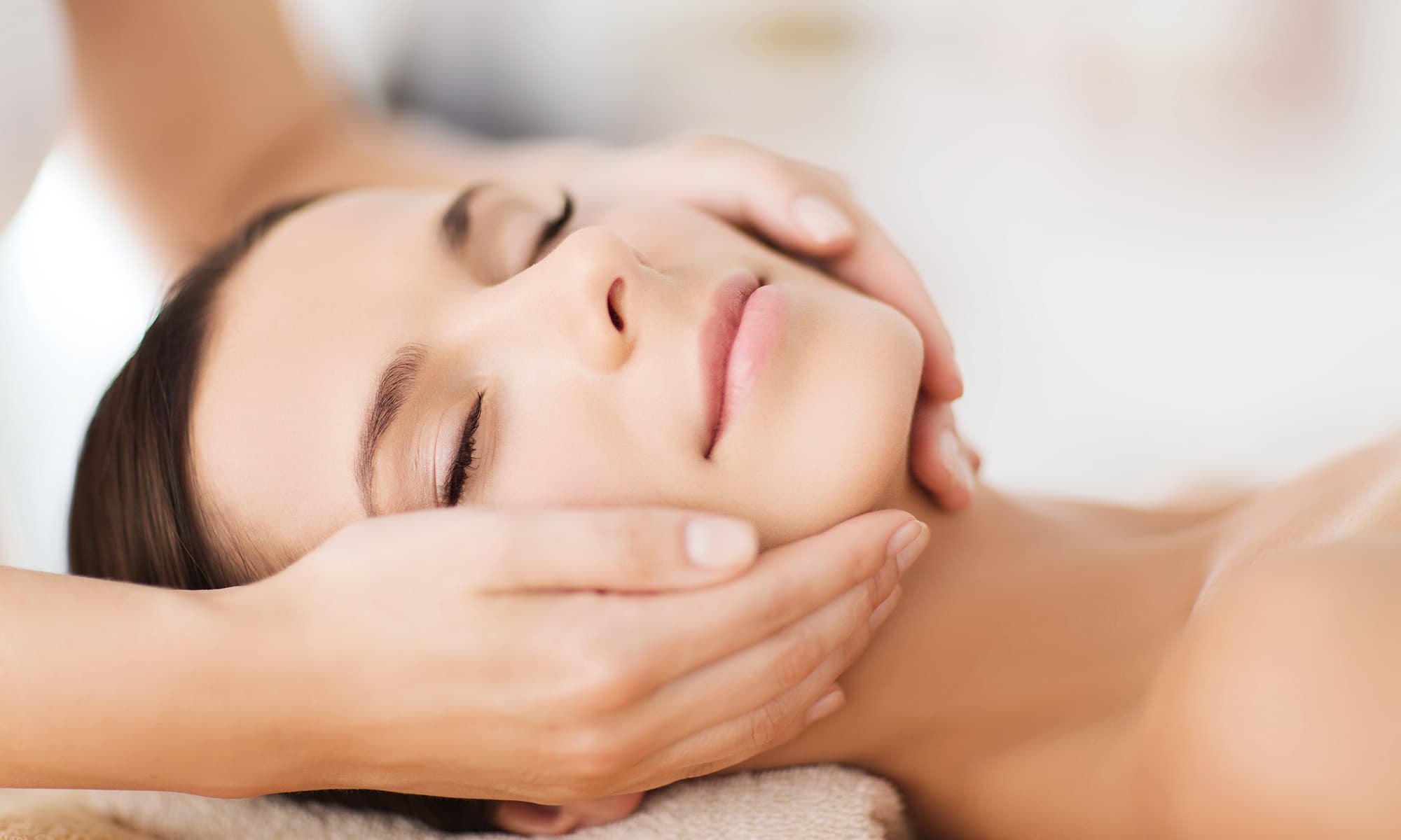  Frau erhält eine entspannende Gesichtsmassage im Kosmetikstudio, Nahaufnahme